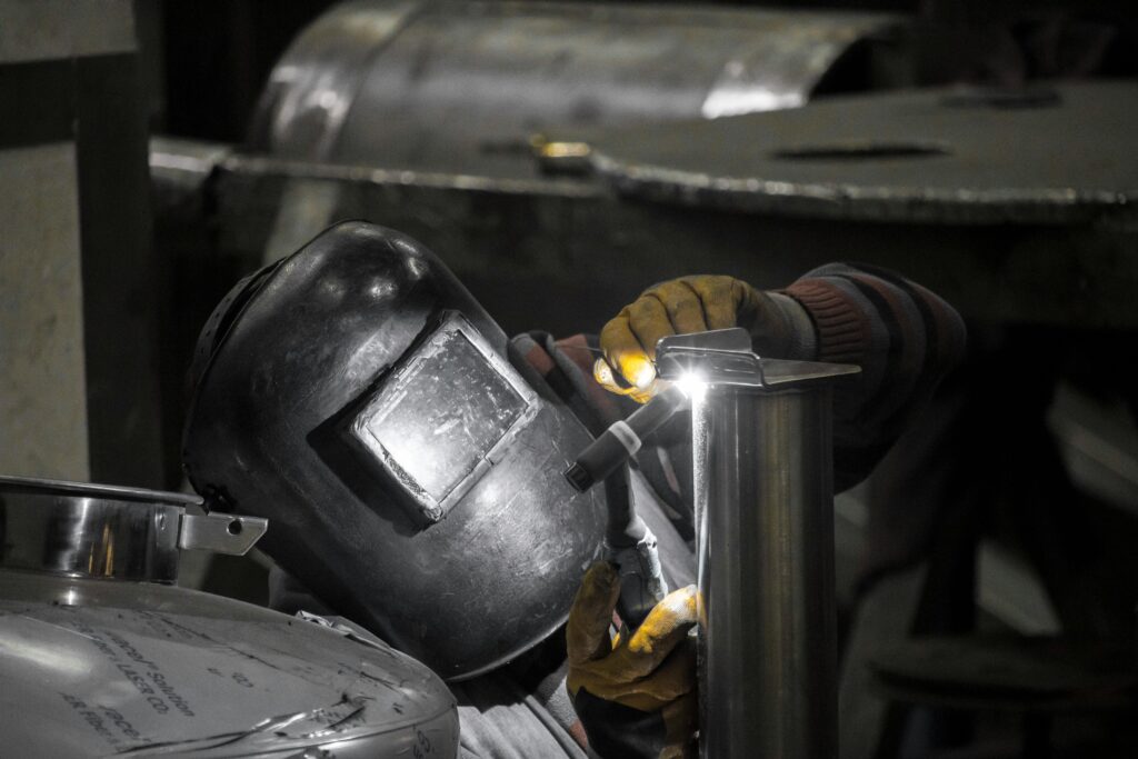 Welder in workshop welding metal parts with precision in İstanbul.